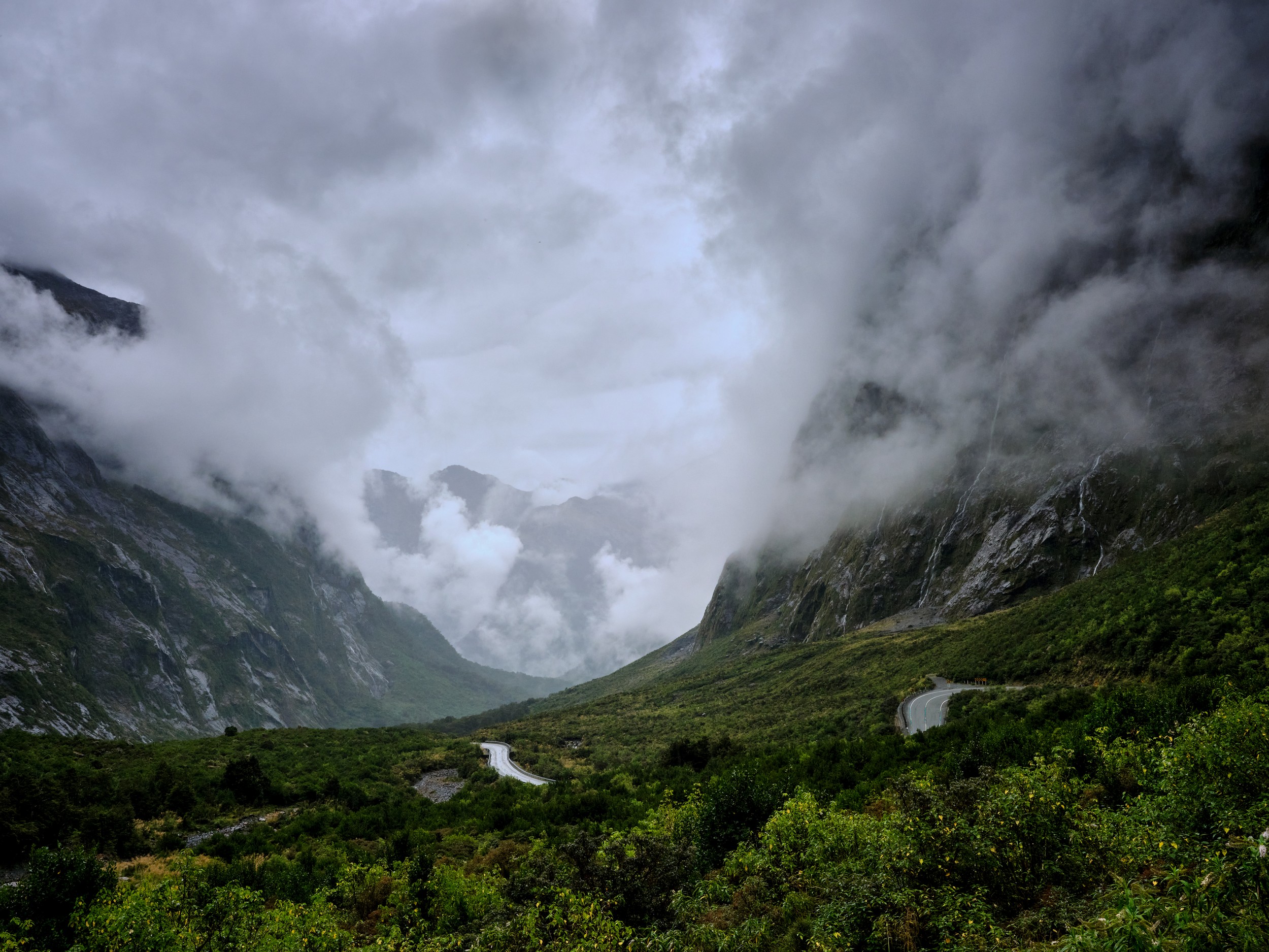 Milford Sound 4 Clouds swirl above the Milford Valley below the Homer Tunnel entrance after heavy weather.