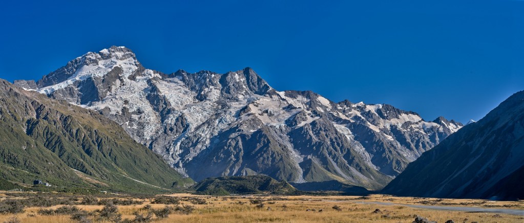 New Zealand 4 Snow capped ranges frame a broad dry valley at the approach to the high Alps.