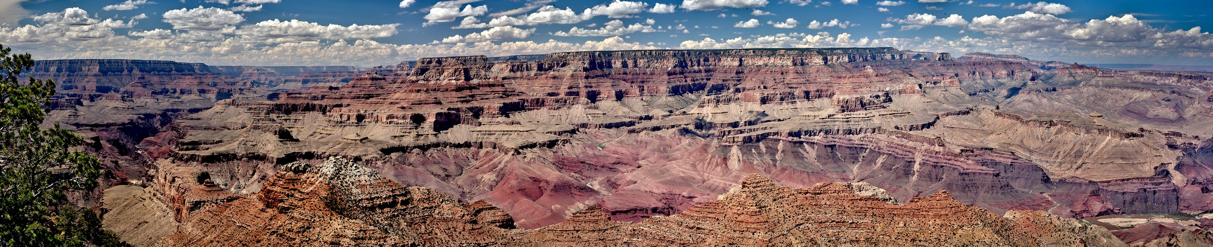 A narrow panorama captures the North Rim and multicolored canyon walls from Navajo Point.