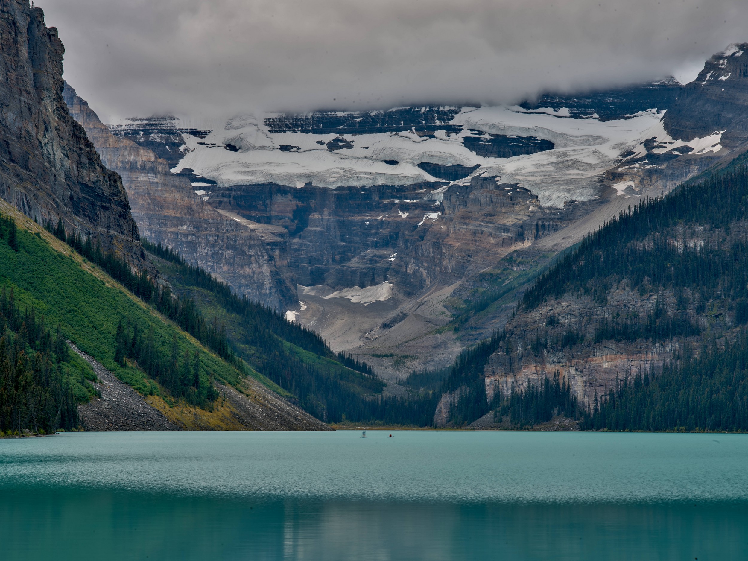 Turquoise Lakes 6 A close view across Lake Louise shows Victoria Glacier, layered cliffs, and low clouds at the end of the valley.